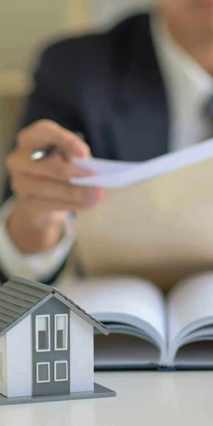 The lawyer is consulting clients about the house purchase contract.